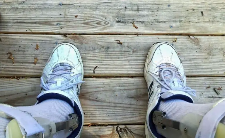 injured man in disability leg braces wearing white nike shoes