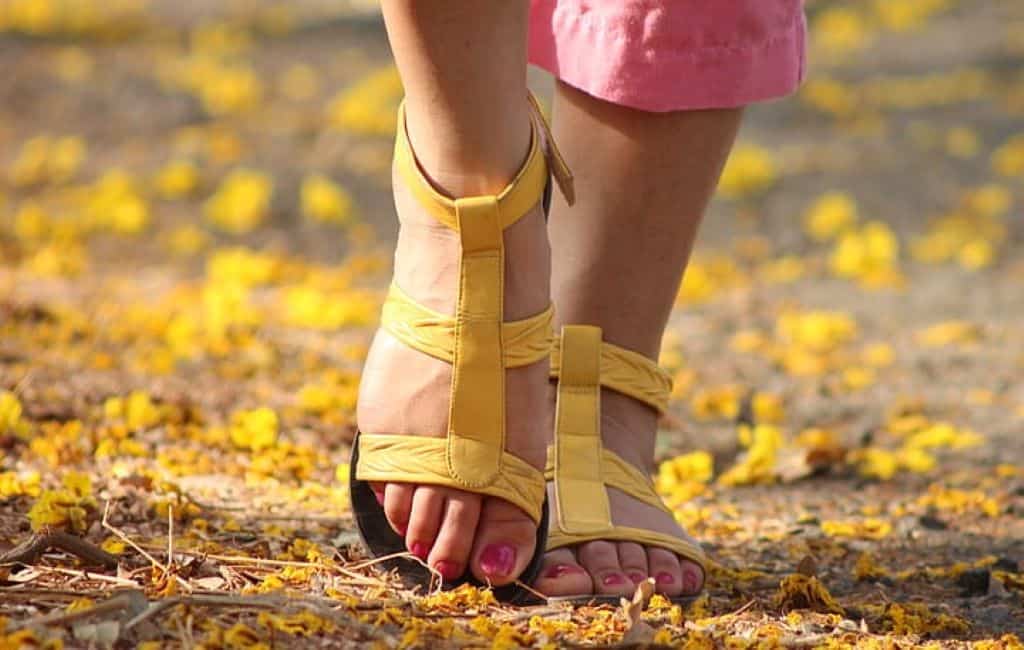 lady wearing yellow sports sandals