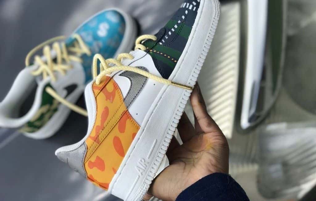 person holding custom nike footwear