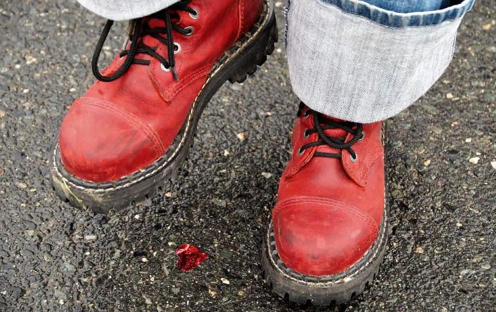 person wearing heavy red steel-toed boots