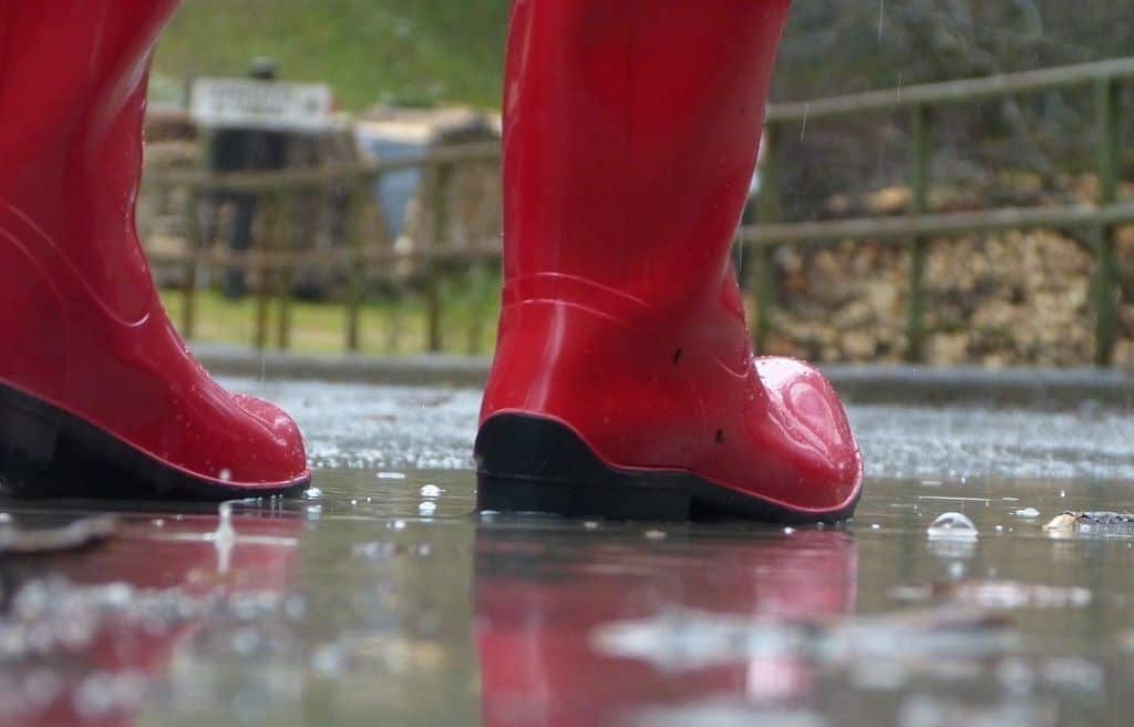 person wearing red boots raindrop rubberboots