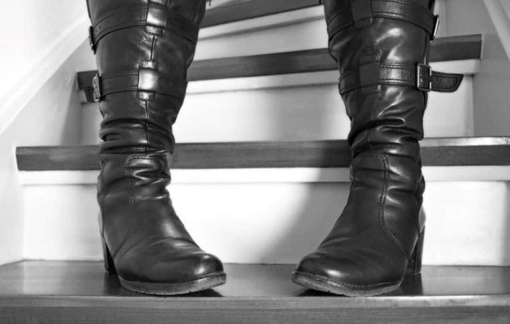 woman in high heel black leather boots