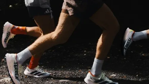 Runners wearing Adidas Terrex Agravic Speed Ultra 2 shoes on a trail